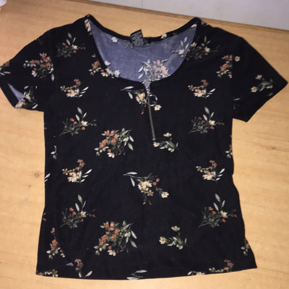 A tight black shirt with flowers on it